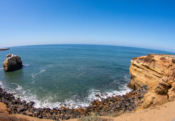 Bird Shit surf break in Sunset Cliffs, San Diego — the guano-capped sea stack standing off the cliff wall.