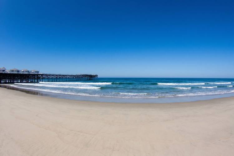 Crystal Pier surf break in Pacific Beach, San Diego — waves breaking alongside the pier pilings.