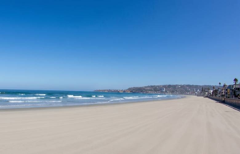 Santa Clara surf break in Pacific Beach, San Diego — beachbreak lines with the La Jolla headland beyond.